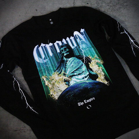 A relaxed-fit unisex long sleeve black shirt by Crown The Empire, made from 100% combed cotton, featuring white lightning graphics on the sleeves and a colorful front design with a statue, yellow flames, a blue planet, and lettering.