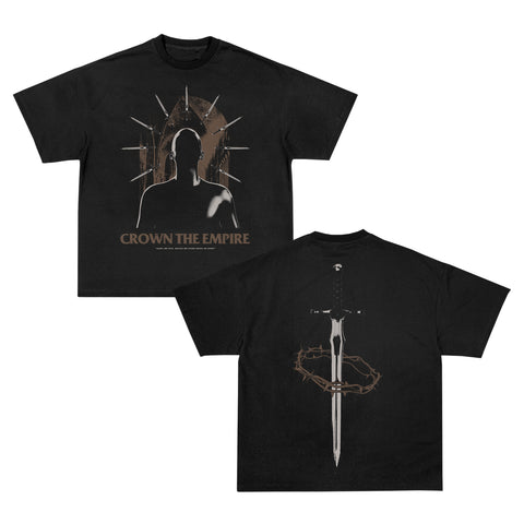 Crown The Empire black heavy cotton unisex tee features a front silhouette graphic with a golden crown and logo, plus a large sword and crown of thorns on the back. Inspired by American Apparel quality.