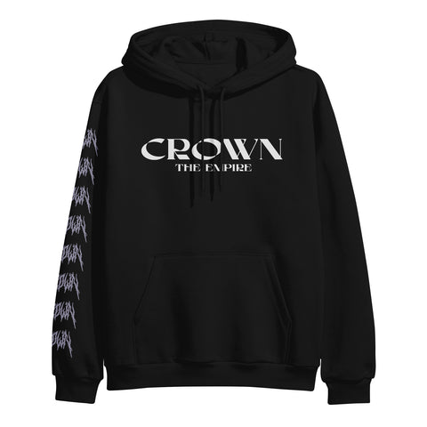 Photo of the front of a black hoodie on a white background. The front of the hoodie says crown the empire in white. The sleeves say Crown on them repeatedly in a death metal font in purple. The back of the hoodie features a purple goblet with a skeleton hand wrapped around it.