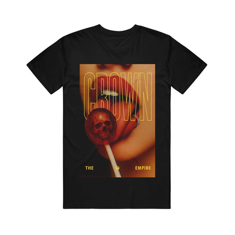 Black Gildan Hammer t-shirt by Crown The Empire featuring lips holding a red lollipop with a skull inside, bold yellow "CROWN" text, and "THE EMPIRE" in smaller letters at the bottom.
