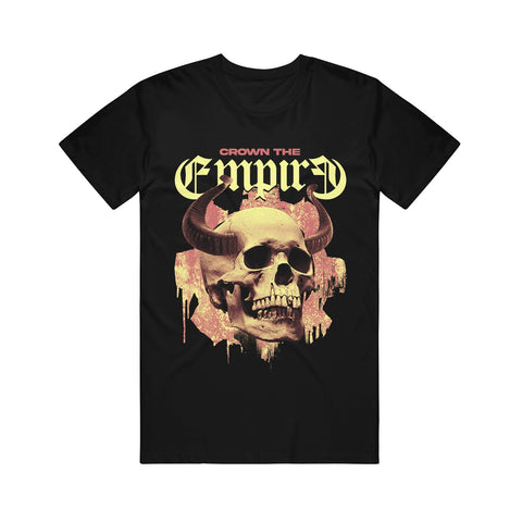 image of a black tee shirt on a white background. tee has full body print of a skull with horns. at the top says crown the empire